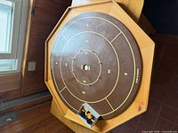 Full view of octagonal crokinole board with discs