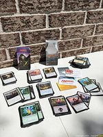 Overall lot showing stacks of MTG cards, deck boxes and insert