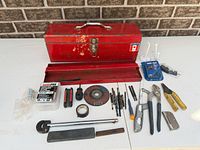 All items in lot laid out including toolbox, tools and hardware