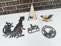 Overview of all five rooster decor items on table