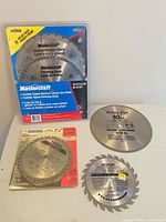Group shot of all five circular saw blades showing packaging and loose blades