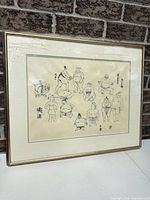 Front view of framed artwork showing full image, mat and gold frame