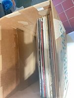 Box containing vertical stack of vinyl records