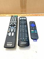 Front view of three remotes: Sony, Bose, Roku