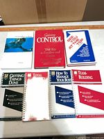 All seven books laid out showing titles and bindings
