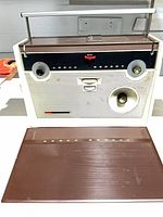 Front view showing Ansco Regent slide projector with detachable brown cover