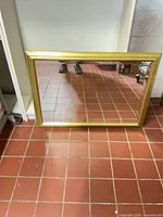 front view showing full mirror and gold frame