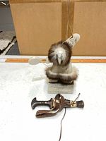 Front view of soapstone bird figurine, knife and sheath