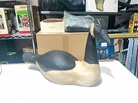 Front three-quarter view of wooden Canada goose decoy