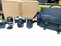 Full lot showing camera, both lenses, flash, filter cases and bag