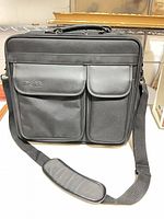 Front view showing Dell laptop bag with two flap pockets and shoulder strap