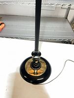 Base, cord and brass accent of floor lamp