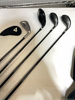 Four clubs laid out showing woods and iron with cover