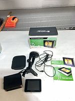 Complete lot: GPS unit, mount, cable, case, manuals, box