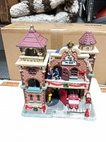 Front view showing Lemax Engine Co No 33 firehouse with figures and fire truck