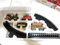 Train set components in molded tray, showing locomotive, cars, track