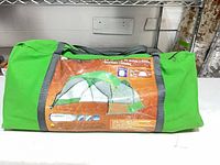 Entire green carry bag with exterior label showing screen house image