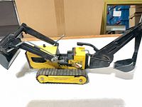 Side view of Tonka tin dozer loader toy