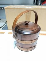 Wooden bucket with lid, handle upright