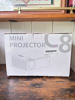 Front of original white box marked Mini Projector C8
