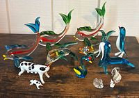 Group shot showing all thirteen glass and crystal figurines on tabletop