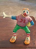 Front view of papier-mâché clown football player figurine