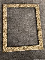 Full view of gold-tone floral filigree metal picture frame