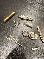 Group shot of all eight antique pocket items on table