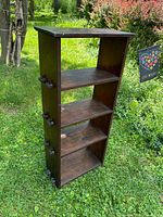 Front and side view of oak bookcase standing on grass