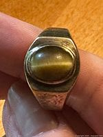 Top view showing oval tiger’s eye cabochon and bezel setting
