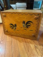 Front view showing rooster artwork and knobs