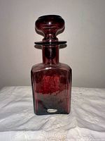 Full view of amethyst Rainbow glass decanter with stopper