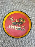 Full view of round metal tray showing design and rim coloration