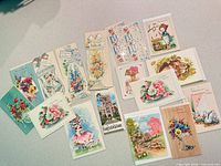 Assortment of seventeen mid-century greeting cards spread on table