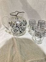 Pitcher and five glasses showing design