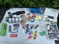 Full layout showing tapes, cutters, scissors, staplers, battery case, organizer