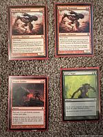 Four sleeved Magic: The Gathering Shards of Alara cards: two Rockslide Elemental, one Dragon Fodder, one Soul's Might