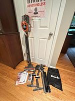 Vacuum assembled upright with all attachments, bag and manual on floor