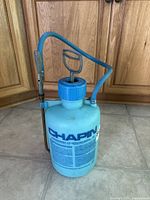 Full view of Chapin blue plastic pump sprayer showing hose and metal wand