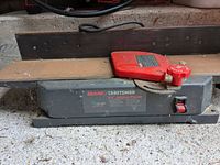 Full view of Craftsman jointer/planer with red push block on bed