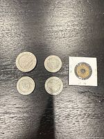 Four vintage casino coins including three Bahamas bimetal tokens and one brass trade token in 2×2 holder