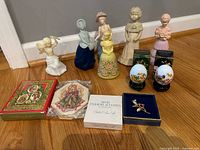 Group shot of all items including perfume figurines, eggs, ornaments, brooch