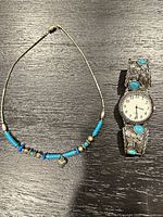 Overall view: turquoise bead necklace and silver-tone filigree cuff watch with turquoise cabochons