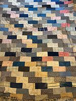 Full view of patchwork quilt topper showing overall pattern and colour variety