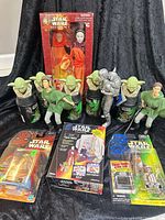 Group shot of all packaged Star Wars items, including Amidala doll, five bubble bath bottles, action figures, and kit