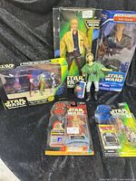 Group shot showing all six items including boxed 12-inch figures, loose Leia, and three carded 3.75-inch figures