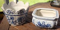 round and square blue-and-white planters side by side