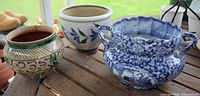 All three ceramic planters on wooden surface