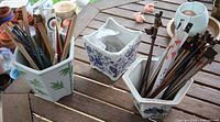 All three ceramic pots on table with contents visible