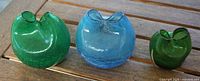 front view of three crackle glass vases